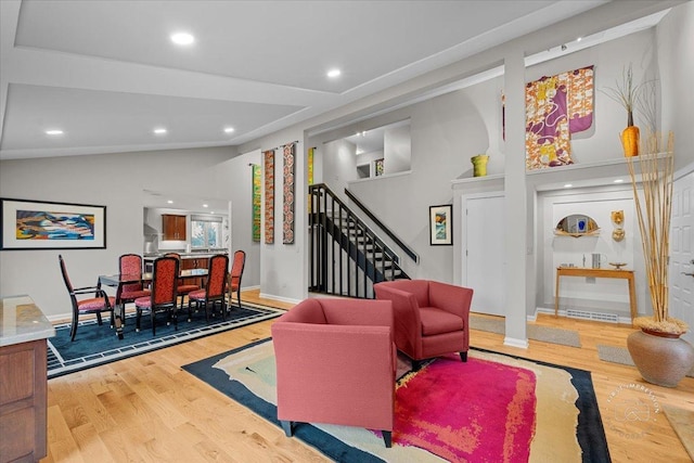 living room featuring vaulted ceiling and wood-type flooring