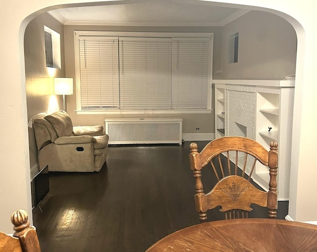 sitting room with radiator, hardwood / wood-style floors, and ornamental molding