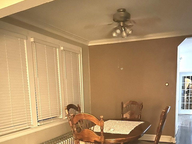 dining area featuring ceiling fan and ornamental molding