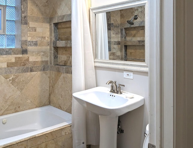 bathroom featuring shower / tub combo and sink