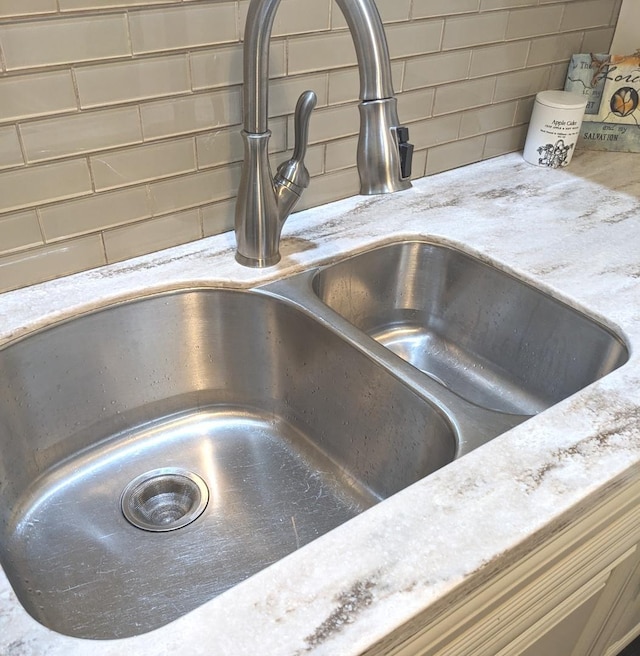 details featuring decorative backsplash and sink