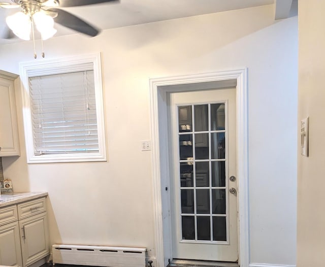 doorway featuring ceiling fan and a baseboard radiator