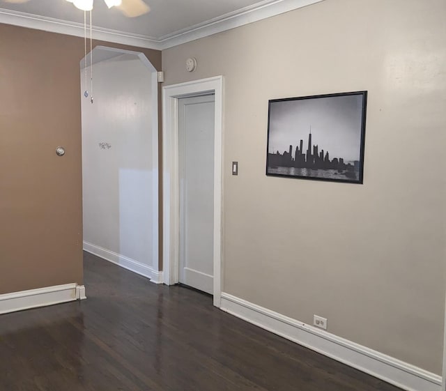 unfurnished room with dark hardwood / wood-style flooring and crown molding