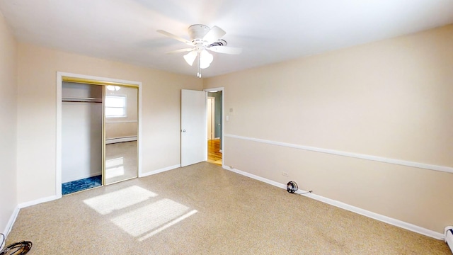 unfurnished bedroom featuring a closet, baseboard heating, and ceiling fan