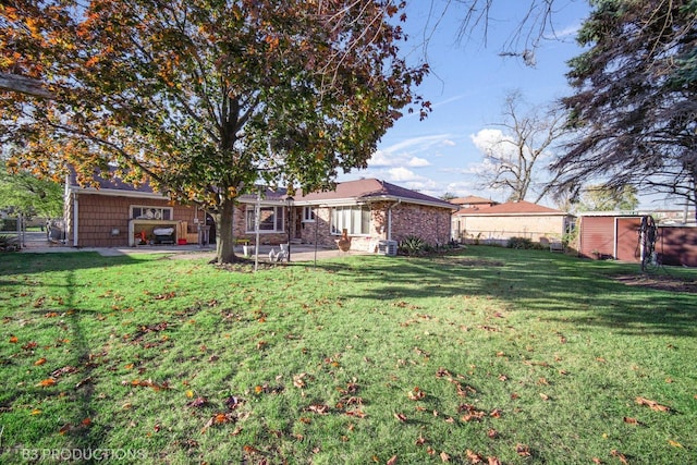 view of yard with a storage unit and a patio