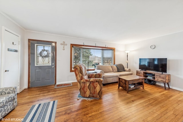 living room with light hardwood / wood-style flooring and ornamental molding