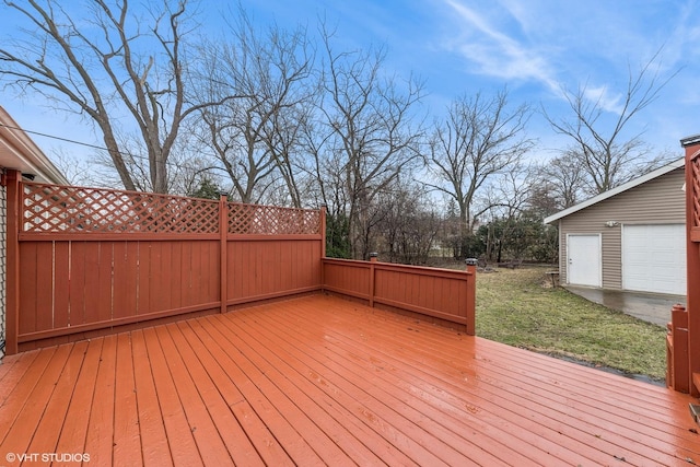 wooden terrace with a lawn and a garage