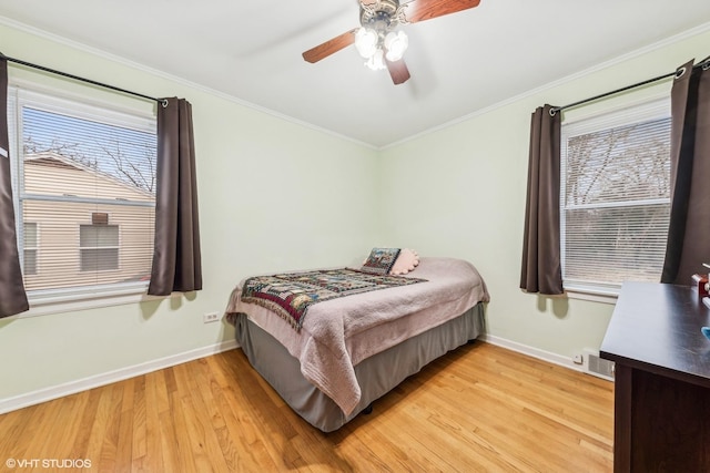 bedroom with ceiling fan, light hardwood / wood-style floors, and ornamental molding