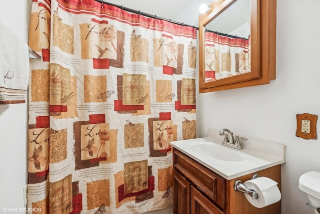 bathroom featuring toilet and vanity