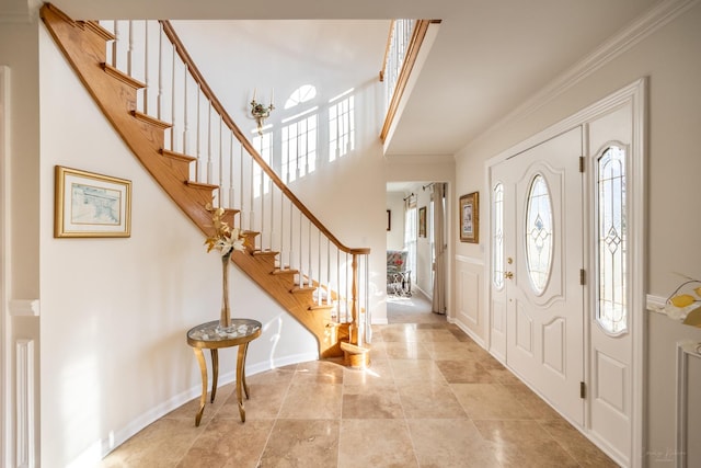 foyer featuring ornamental molding