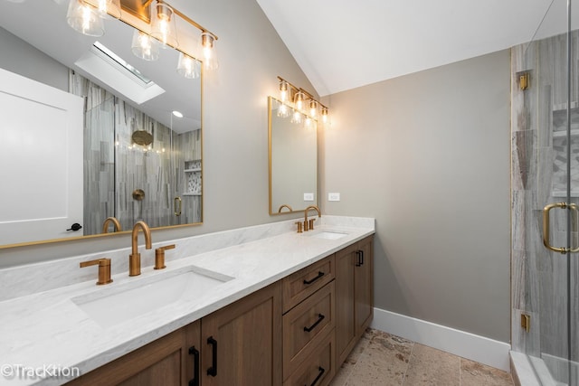 bathroom featuring vanity, lofted ceiling with skylight, and walk in shower