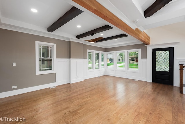 unfurnished living room featuring beam ceiling, light hardwood / wood-style flooring, and ceiling fan