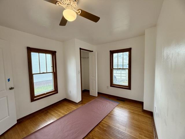 unfurnished bedroom with light hardwood / wood-style flooring and ceiling fan