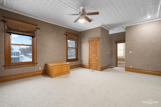 unfurnished bedroom featuring carpet floors, ceiling fan, and crown molding