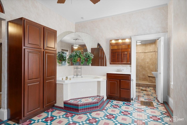 bathroom featuring vanity, ornamental molding, and a bath