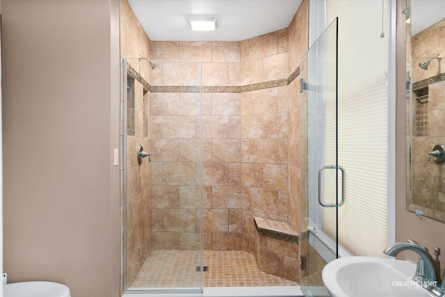 bathroom featuring sink and a shower with shower door