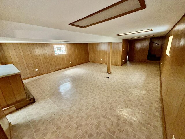 7618 S Rhodes Ave, Chicago, IL 60619 - basement with wood walls, light floors, baseboards, and a textured ceiling