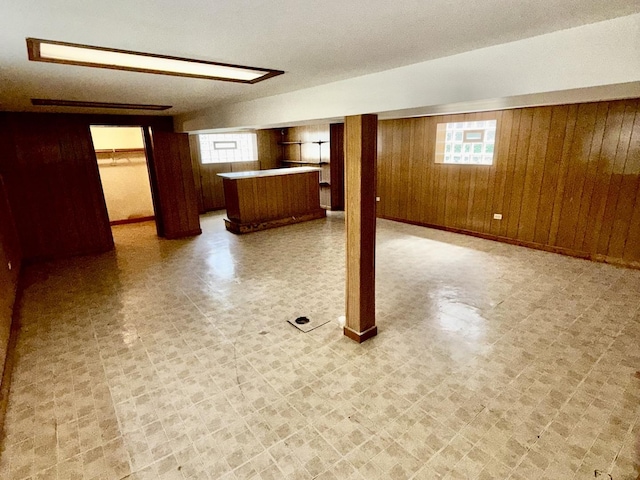 7618 S Rhodes Ave, Chicago, IL 60619 - below grade area with tile patterned floors, wooden walls, and bar
