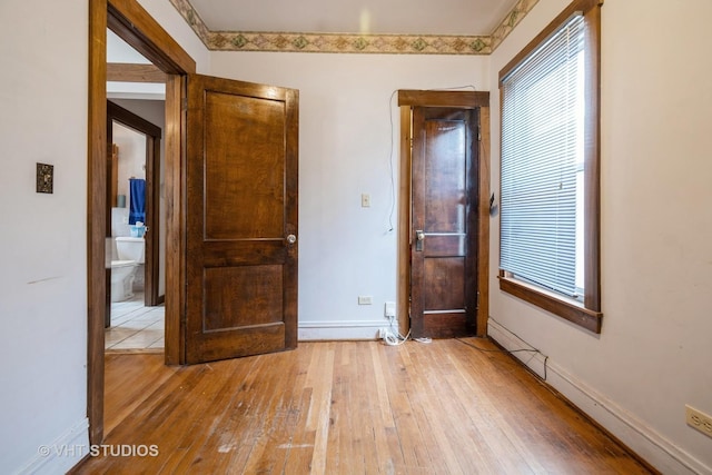 unfurnished bedroom featuring light wood-type flooring