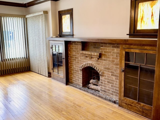 7618 S Rhodes Ave, Chicago, IL 60619 - unfurnished living room featuring hardwood / wood-style floors and a brick fireplace