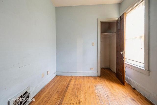 unfurnished bedroom featuring a closet and light hardwood / wood-style flooring