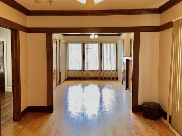 7618 S Rhodes Ave, Chicago, IL 60619 - unfurnished living room featuring hardwood / wood-style flooring, ornamental molding, a ceiling fan, baseboards, and a fireplace