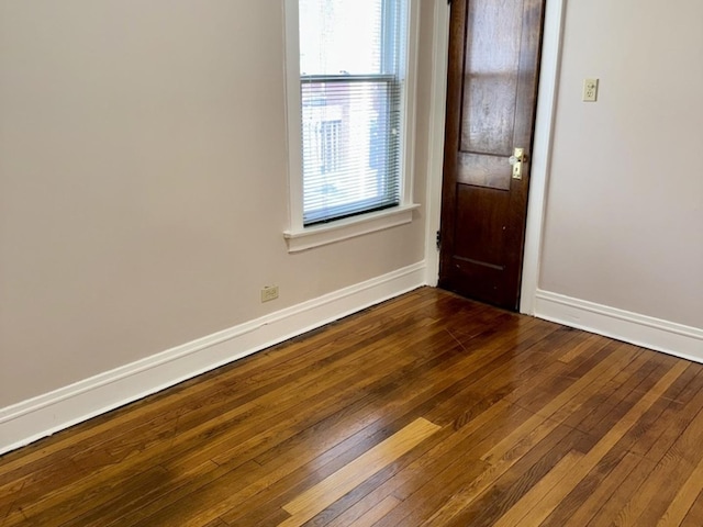 7618 S Rhodes Ave, Chicago, IL 60619 - spare room featuring baseboards, dark wood-style floors, and plenty of natural light