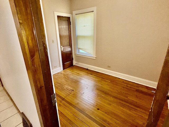 7618 S Rhodes Ave, Chicago, IL 60619 - unfurnished bedroom with wood-type flooring and baseboards