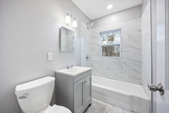 full bathroom featuring tiled shower / bath combo, toilet, and vanity