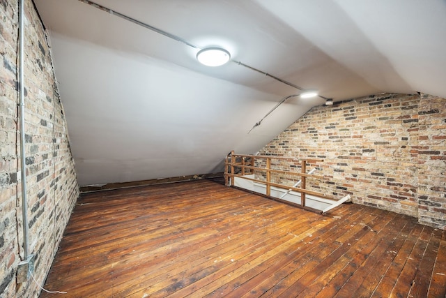 additional living space featuring dark hardwood / wood-style flooring and vaulted ceiling