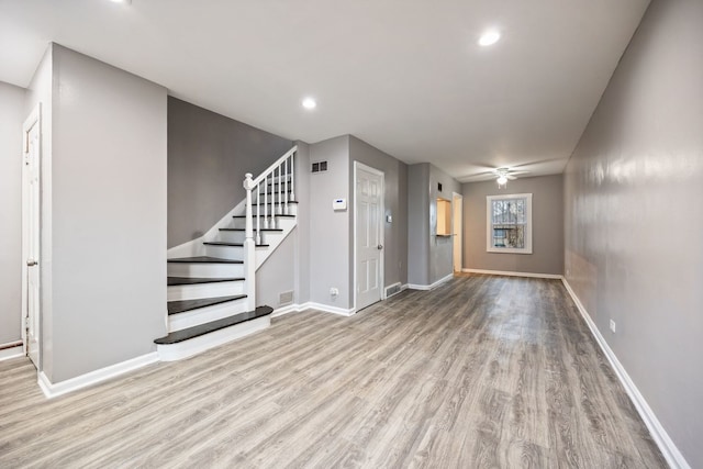 unfurnished living room with ceiling fan and light hardwood / wood-style floors