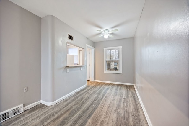 spare room featuring hardwood / wood-style floors and ceiling fan