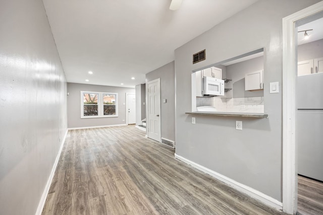 unfurnished living room featuring dark hardwood / wood-style flooring