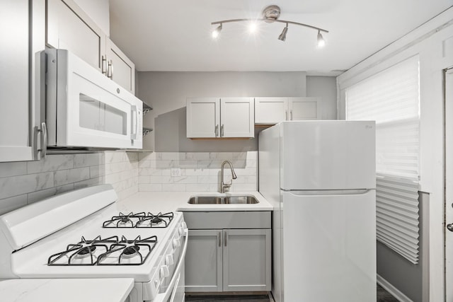 kitchen featuring white cabinets, white appliances, tasteful backsplash, and sink