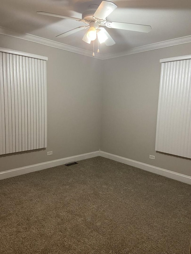 carpeted empty room with crown molding and ceiling fan