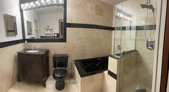 full bathroom featuring tile patterned floors, vanity, tile walls, plus walk in shower, and toilet