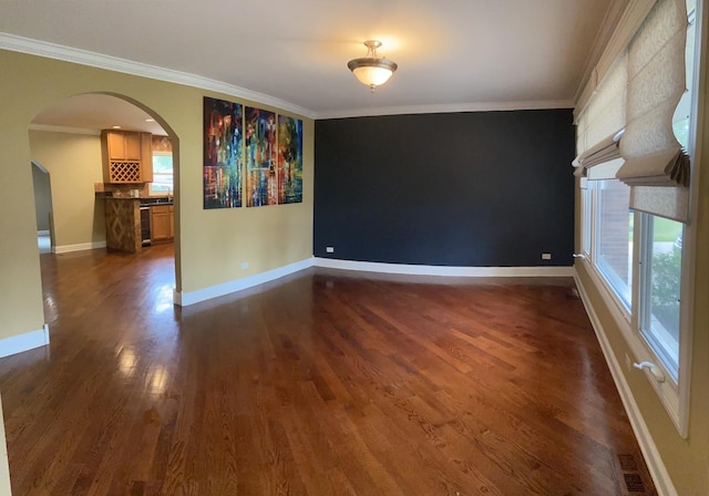 unfurnished room featuring crown molding and dark hardwood / wood-style flooring