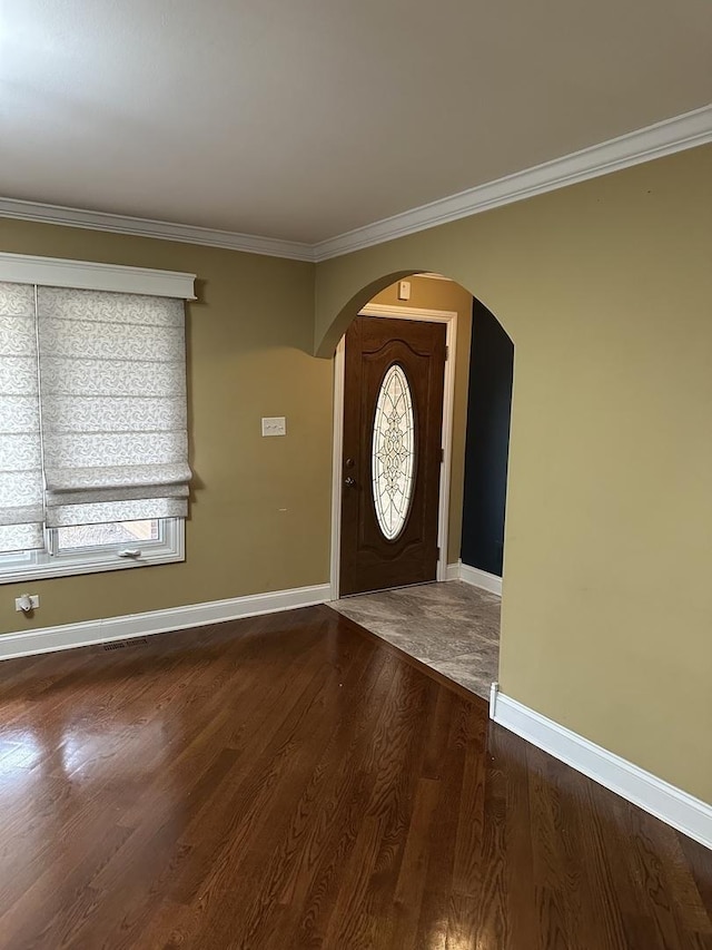 entrance foyer with hardwood / wood-style floors and crown molding