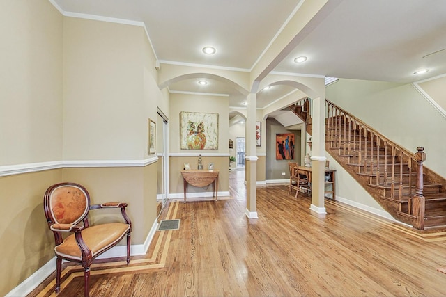 interior space with hardwood / wood-style flooring and crown molding