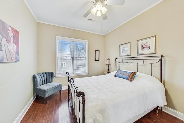 bedroom with ornamental molding, ceiling fan, and dark wood-type flooring