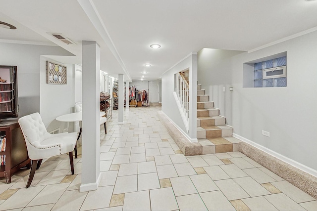 foyer with light tile patterned floors and ornamental molding