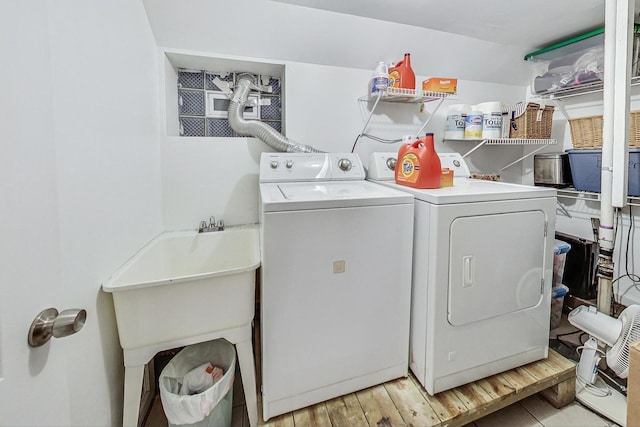 washroom with light hardwood / wood-style floors and independent washer and dryer