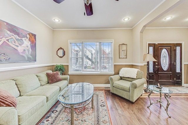 living room featuring crown molding and hardwood / wood-style flooring