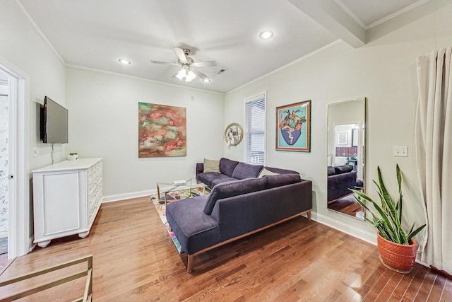 living room with light wood-type flooring, ceiling fan, and crown molding