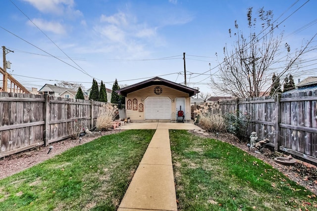 view of yard featuring a garage and an outbuilding