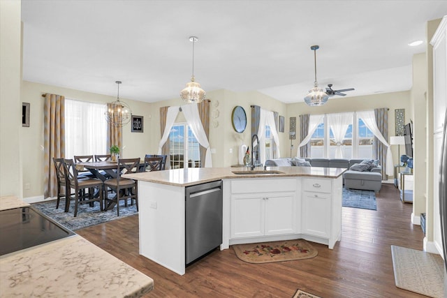 kitchen featuring dishwasher, sink, an island with sink, white cabinets, and ceiling fan with notable chandelier