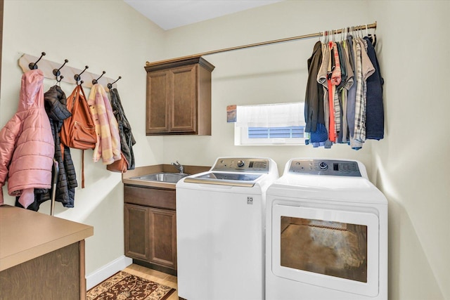 laundry area with sink, cabinets, and independent washer and dryer