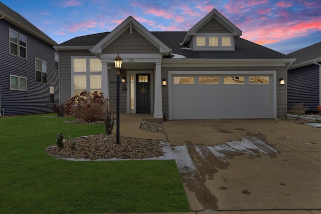 view of front of property featuring a lawn and a garage