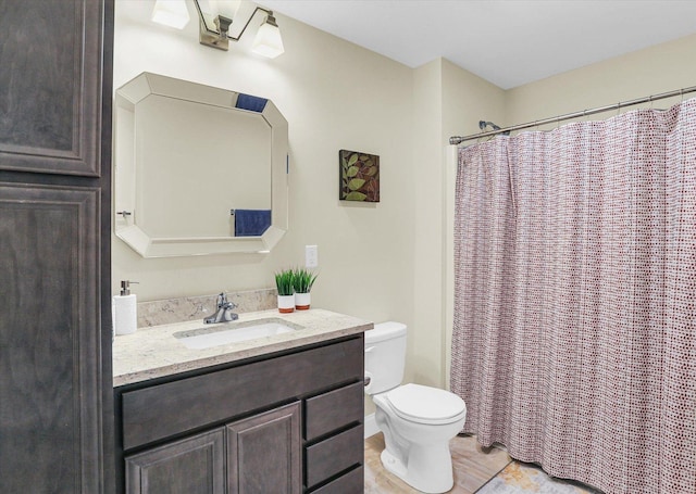 bathroom with vanity, toilet, and walk in shower