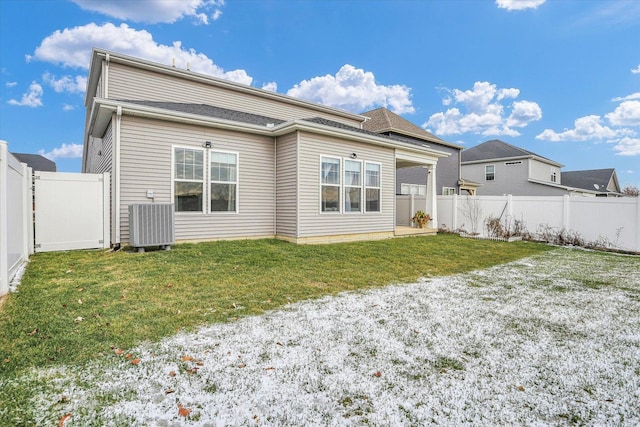 back of house featuring a lawn and central AC